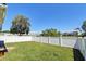 Lush green backyard with a white privacy fence and mature trees in the distance at 132 Lynches River Dr, Summerville, SC 29485