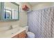 Well-lit bathroom with a vanity, toilet, and shower-tub combo with patterned curtain at 132 Lynches River Dr, Summerville, SC 29485