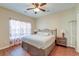Comfortable bedroom features wood-look floors, a ceiling fan, and natural light from the window at 132 Lynches River Dr, Summerville, SC 29485