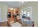 Open-concept dining area offering a view of the kitchen and sunroom at 132 Lynches River Dr, Summerville, SC 29485