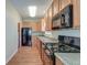 Bright kitchen featuring wood cabinets, black appliances, and durable laminate flooring at 132 Lynches River Dr, Summerville, SC 29485