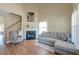 Comfortable living room with fireplace, staircase, and a large sectional sofa at 132 Lynches River Dr, Summerville, SC 29485