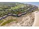 Scenic aerial of beachfront condos near a boardwalk, showcasing direct access to sandy shores at 1332 Pelican Watch Villas, Seabrook Island, SC 29455