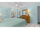 Bedroom with a dresser, queen bed, tile flooring, and lots of natural light at 1332 Pelican Watch Villas, Seabrook Island, SC 29455