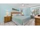 Cozy bedroom with a queen bed, tile flooring, and lots of natural light at 1332 Pelican Watch Villas, Seabrook Island, SC 29455