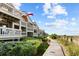 Multi-level condo complex with decks and a beach boardwalk in view at 1332 Pelican Watch Villas, Seabrook Island, SC 29455