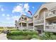 Multi-level condo complex showcasing decks and lush landscaping at 1332 Pelican Watch Villas, Seabrook Island, SC 29455