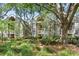 Inviting building exterior with lush greenery and mature trees offering shade at 1332 Pelican Watch Villas, Seabrook Island, SC 29455