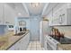 Galley kitchen with granite counters, stainless appliances, and ample storage at 1332 Pelican Watch Villas, Seabrook Island, SC 29455