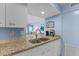 Well-lit kitchen with stainless sink, granite countertops, and modern appliances at 1332 Pelican Watch Villas, Seabrook Island, SC 29455