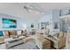 Bright and airy living area with comfortable seating, ceiling fan, and open to dining area at 1332 Pelican Watch Villas, Seabrook Island, SC 29455