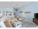 Open concept living area with tile flooring and view into kitchen and dining area at 1332 Pelican Watch Villas, Seabrook Island, SC 29455