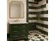 A modern bathroom with a striped shower and vanity with gold fixtures at 134 Spring St, Charleston, SC 29403
