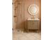 This bathroom offers a glass shower and a stylish mirror and vanity with gold fixtures at 134 Spring St, Charleston, SC 29403