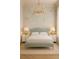 A cozy bedroom is accentuated with a floral wallpaper and a vintage chandelier at 134 Spring St, Charleston, SC 29403