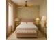 A well-lit bedroom with a ceiling fan, floral wallpaper, and a tufted bench at 134 Spring St, Charleston, SC 29403