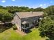 Back exterior showing deck, screened in patio and lush landscaping at 1349 Hamlin Park Cir, Mount Pleasant, SC 29466