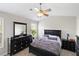 This cozy bedroom features dark furniture, a ceiling fan, and plush bedding at 1349 Hamlin Park Cir, Mount Pleasant, SC 29466