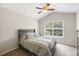 Well-lit bedroom with plush carpet, gray bedding, and large window view at 1349 Hamlin Park Cir, Mount Pleasant, SC 29466