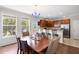 Bright dining area adjacent to the kitchen, featuring hardwood floors and a stylish chandelier at 1349 Hamlin Park Cir, Mount Pleasant, SC 29466