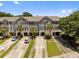 Gorgeous exterior shot of a townhome featuring mature landscaping and garage parking at 1349 Hamlin Park Cir, Mount Pleasant, SC 29466