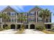 Inviting townhome with a meticulously maintained lawn and mature palm trees enhancing its curb appeal at 1349 Hamlin Park Cir, Mount Pleasant, SC 29466