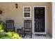 Charming front porch with rocking chairs invites relaxation by the black front door at 1349 Hamlin Park Cir, Mount Pleasant, SC 29466