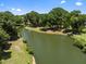 Scenic aerial view of a peaceful pond surrounded by lush green trees and grassy banks at 1349 Hamlin Park Cir, Mount Pleasant, SC 29466
