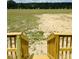 Enjoy the view of the large backyard with the wooden stairs leading down from the porch at 1358 Givhans Rd, Ridgeville, SC 29472