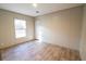 Neutral bedroom with light-colored walls, light-colored wood-look floors, window and closet at 1358 Givhans Rd, Ridgeville, SC 29472