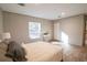 Comfortable bedroom featuring wood floors, a well-lit window, and minimalist décor at 1358 Givhans Rd, Ridgeville, SC 29472