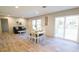 Bright dining area featuring modern lighting, wood floors, and sliding glass doors to outside at 1358 Givhans Rd, Ridgeville, SC 29472