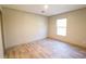 An empty room shows laminate wood-look flooring, white walls, and a bright window at 1358 Givhans Rd, Ridgeville, SC 29472