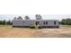 Backyard view of a light-gray home with a wooden deck and sliding glass doors at 1358 Givhans Rd, Ridgeville, SC 29472