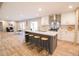 Bright and open kitchen with a large island, stainless steel appliances, and a view to the dining area at 1358 Givhans Rd, Ridgeville, SC 29472