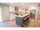 Modern kitchen with gray island, stainless steel appliances, sleek countertops, and ample cabinet space at 1358 Givhans Rd, Ridgeville, SC 29472