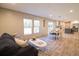 Inviting living room featuring wood floors, ample natural light, and seamless flow to dining and kitchen at 1358 Givhans Rd, Ridgeville, SC 29472