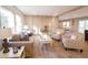 Bright living room features a comfortable sofa, two armchairs, wood flooring, and plenty of natural light at 1358 Givhans Rd, Ridgeville, SC 29472