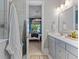 Bright bathroom with gray vanity, quartz countertop, and a view into the bedroom at 137 Low Tide Ct, Charleston, SC 29492