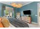 Bedroom with gray bedding, turquoise walls, and natural light coming from the windows at 137 Low Tide Ct, Charleston, SC 29492