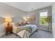 Cozy bedroom with a bed with end tables, lamps, and a window with natural light at 137 Low Tide Ct, Charleston, SC 29492