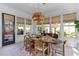 Dining room with light colored wood table, rug, and abundant natural light from multiple windows at 137 Low Tide Ct, Charleston, SC 29492