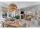 Bright dining room with decorative light fixture and fireplace adjacent to a living room at 137 Low Tide Ct, Charleston, SC 29492
