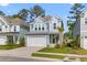 Charming two-story home showcasing a manicured lawn, a two-car garage, and appealing curb appeal at 137 Low Tide Ct, Charleston, SC 29492