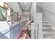 Inviting hallway with wainscoting, decorative art, rug runner, and a staircase at 137 Low Tide Ct, Charleston, SC 29492