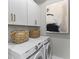 The well-equipped laundry room features modern appliances, ample storage, and a decorative wall art at 137 Low Tide Ct, Charleston, SC 29492