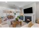Bright and airy living space with a fireplace and view into dining room at 137 Low Tide Ct, Charleston, SC 29492