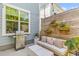 Cozy outdoor patio with grill, seating, privacy screen, and potted flowers at 137 Low Tide Ct, Charleston, SC 29492