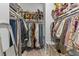 Spacious walk-in closet features custom shelving and ample hanging storage for optimal organization at 137 Low Tide Ct, Charleston, SC 29492