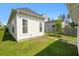 Well-maintained backyard showcasing lush grass, a charming yellow home, and some greenery at 139 Clear Bend Ln, Summerville, SC 29486